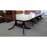 A George III style mahogany four pillar extending dining table, on sixteen downswept supports,