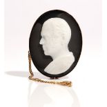 An oval carved agate cameo brooch, designed as the portrait of a gentleman,