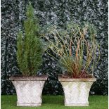 A pair of reconstituted square stone planters with flared lattice moulded bodies,