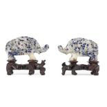 A pair of Chinese lapis lazuli figures of standing elephants, 20th century, 9cm long, wood stands.