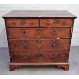 An early 18th century featherbanded walnut chest with two short and three long graduated drawers on