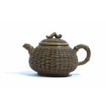 A Chinese Yixing teapot and cover, the compressed body moulded with basketwork,