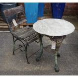 An early 20th century cast iron garden table with associated white marble circular top,