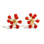 A pair of gold and coral bead earclips, each of marine life form, with a textured finish,