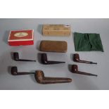 A quantity of early 20th century wooden smoking pipes including a silver mounted Bakelite example