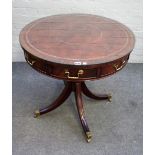 A George III style mahogany drum table with six dummy and one true frieze drawer,