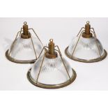 A set of three modern brass and holophane glass industrial ceiling lights, 34cm high (3).