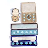 A set of six silver and enamelled buttons, decorated with pale blue and white enamel,