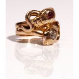 A gold, ruby and diamond ring, designed as two entwined snakes,