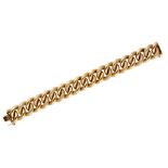 A gold bracelet, in an alternating decorated and plain hollow large curb link design,