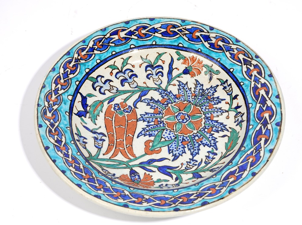 An Iznik style earthenware dish, probably late 19th century, painted with a tulip,