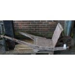 A 19th century hardwood barrel wheelbarrow, 210cm wide x 87cm high.