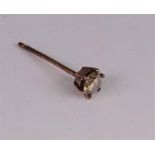 A single diamond earstud, the brilliant cut brown diamond approximately 0.