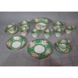 A 19th century porcelain part tea service green decoration and gilt border.