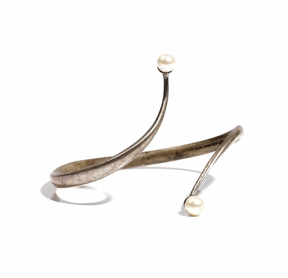 A Georg Jensen Torun silver and cultured pearl bangle, in a twistover design,