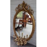 A 19th century gilt framed oval mirror with acanthus swag,