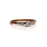 A gold and platinum ring, claw set with the principal circular cut diamond at the centre,