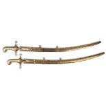 Two Islamic gold damascened steel sword scabbards, length 93cm and two hilts, 20th century,