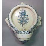 A Victorian style urinal with printed floral pattern, 46cm. high.