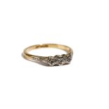 A gold and platinum, diamond set three stone ring, mounted with variously cut diamonds,