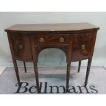 A William IV mahogany bowfront sideboard on turned supports, 114cm wide x 91cm high.