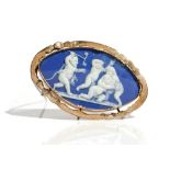 A gold mounted oval blue and white jasperware cameo brooch, designed as a group of three putto,