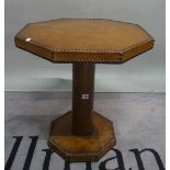 A mid 20th century stained beech and leather upholstered octagonal low centre table,