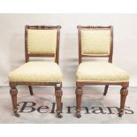 A set of four Victorian style mahogany framed dining chairs on fluted tapering supports,
