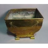 An Edwardian copper coal bucket of tapering square form on bracket feet, 42cm wide x 31cm high.