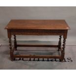 A late Victorian oak two drawer side table on barley twist supports, 114cm wide x 74cm high.