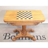 A Victorian inlaid rosewood card table on turned, octagonal column on four claw supports,