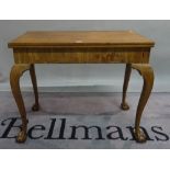 A Victorian mahognay foldover card table on ball and claw supports,