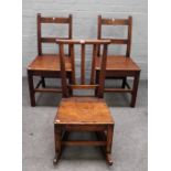 An oak rocking chair, 18th century, with triple splat back and solid seat, 43cm wide x 84cm high,