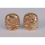 A pair of 18ct gold and diamond set earclips of rounded rectangular abstract design,