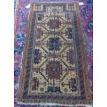 A Beluchistan prayer rug, the pale caramel mehrab with three stylised medallions,