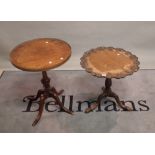 A Victorian mahogany low tripod table with carved top on three outswept supports,