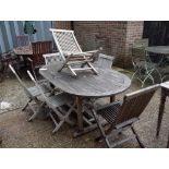A teak oval extending garden table, 100cm wide x 180cm x long x 240cm long extended,