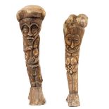 An Inuit whale bone carving of a tribal figure, 56cm high, together with another smaller example.
