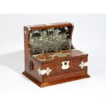 An Edwardian silver metal mounted oak tantalus with lift top compartment over drawer,