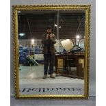 A modern gold painted rectangular mirror with bevelled glass, 120cm wide x 151cm high.