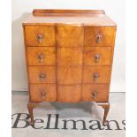 A modern walnut chest of four long drawers on cabriole supports, 75cm wide x 108cm high.