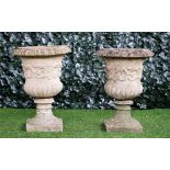 A pair of reconstituted stone jardinieres with semi-fluted bodies and turned socle,