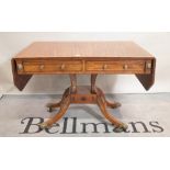 A late 19th century mahogany and ebony inlaid sofa table on four outswept supports,
