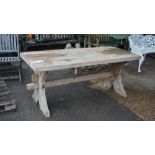 A thick set rectangular pine trestle table, on X-frame supports, 78cm wide x 181cm high.