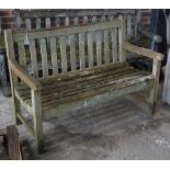 A teak garden bench of slatted construction, 122cm wide x 85cm high.