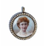 A gold and seed pearl set circular pendant locket, circa 1910,