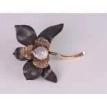 A baroque cultured pearl, gold, oxidised precious metal and diamond set brooch of flower design,