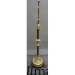 An early 20th century brass standard lamp with a reeded column on claw supports, 153cm high.