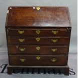 A George III mahogany bureau with four long graduated drawers on bracket feet,