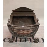 A cast iron bowfront fire basket with tapered finials, 57cm wide.